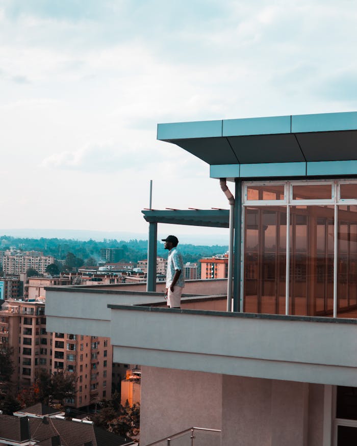 Man Standing on Balcony
